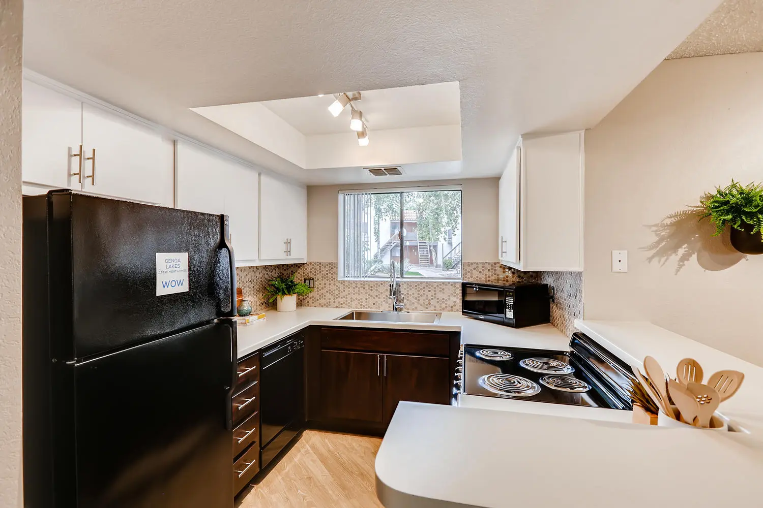 Kitchen with black appliances at Genoa Lakes apartments for rent in Mesa, AZ